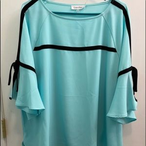 Calvin Klein turquoise blouse with black trim.